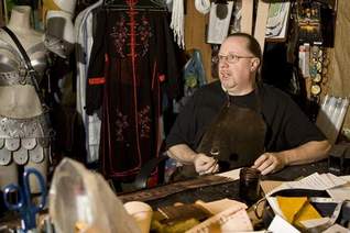 Leather crafter Chip Lorimer works on a belt in his workshop.